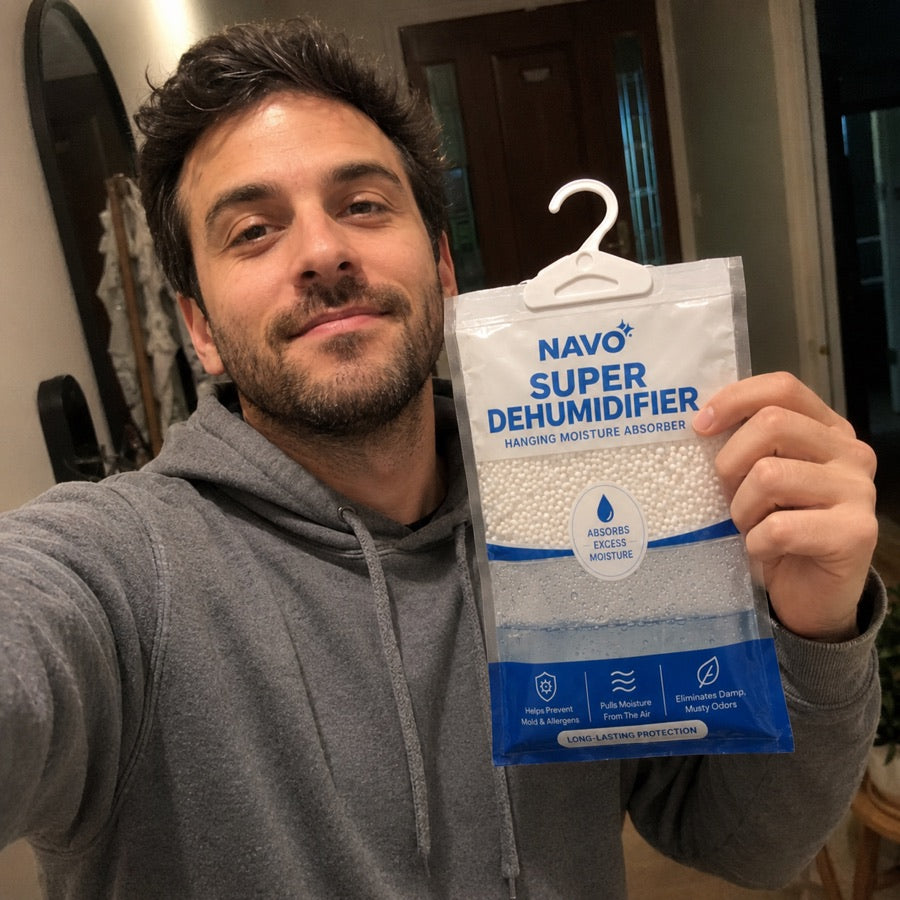 NAVO customer holding a hanging moisture absorber at home