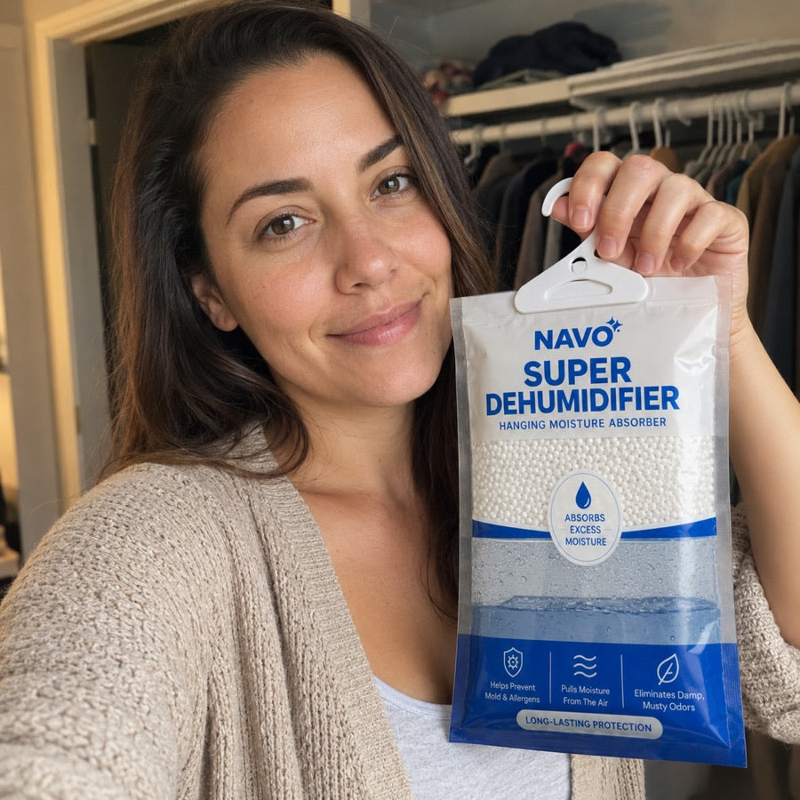 NAVO customer holding a hanging moisture absorber in a closet