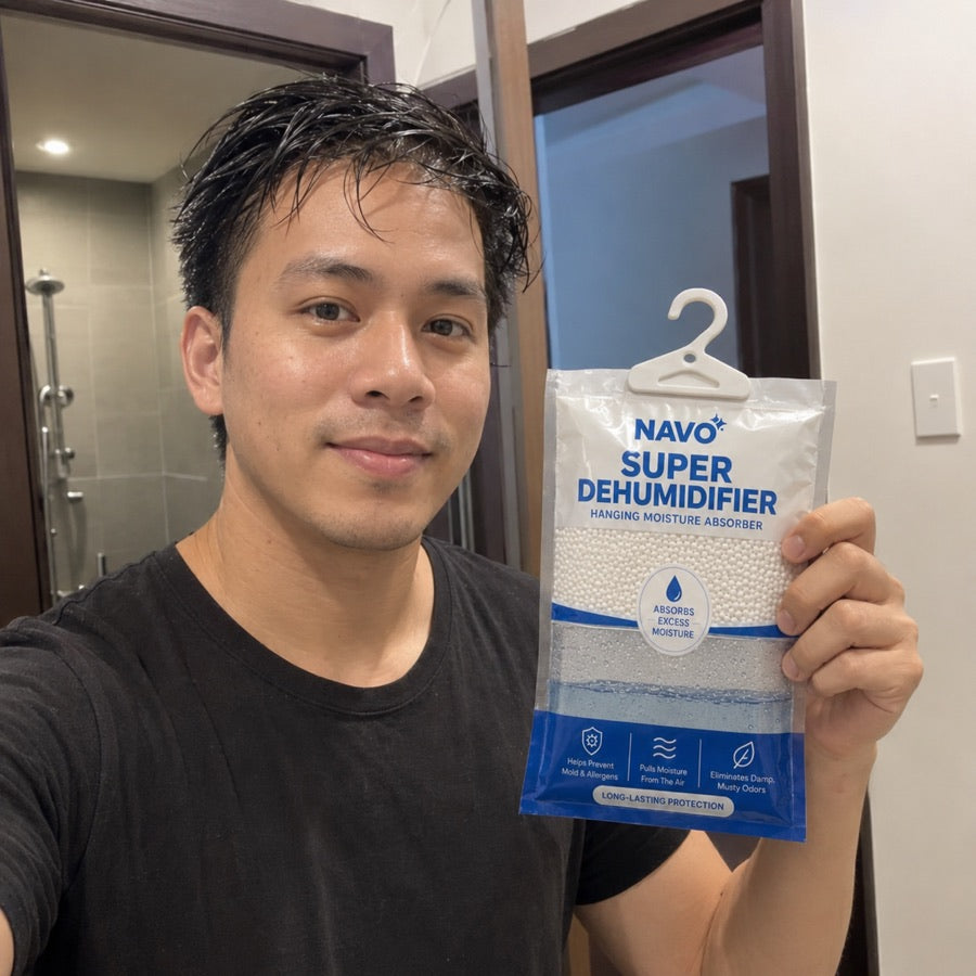 NAVO customer holding a hanging moisture absorber in a bathroom
